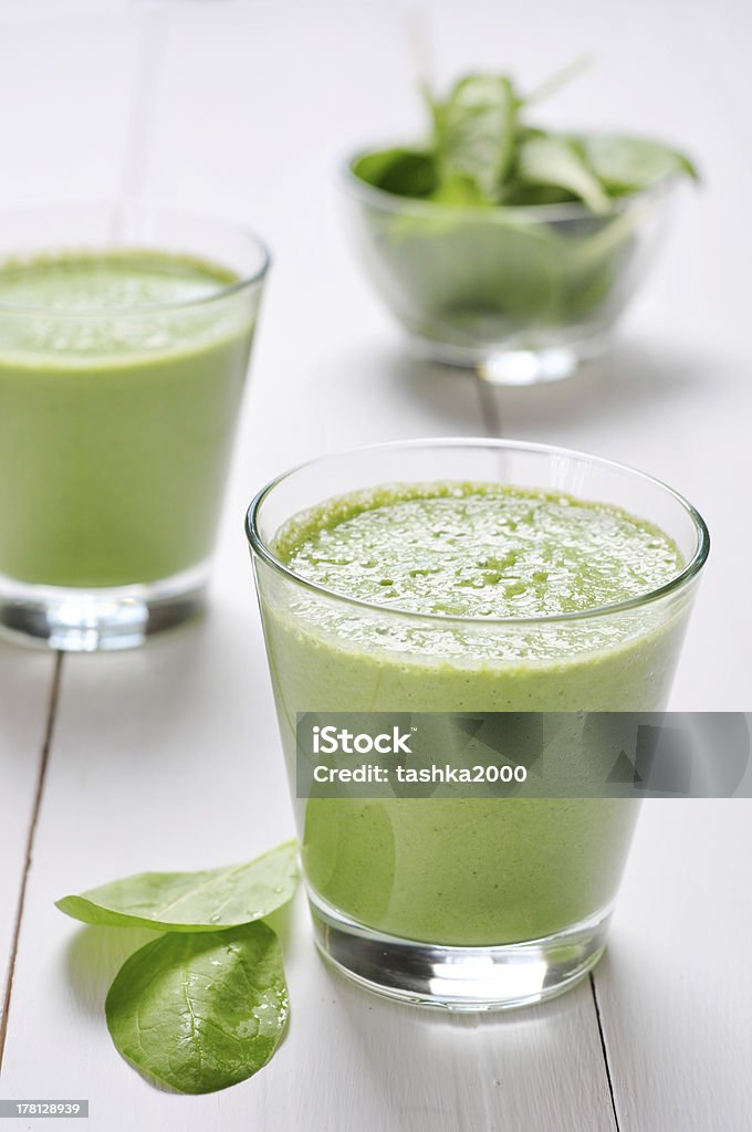 Spinach smoothies Spinach smoothies in glass on a wooden background Cocktail Stock Photo
