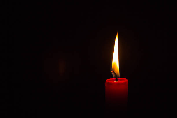 One lit candle stock photo