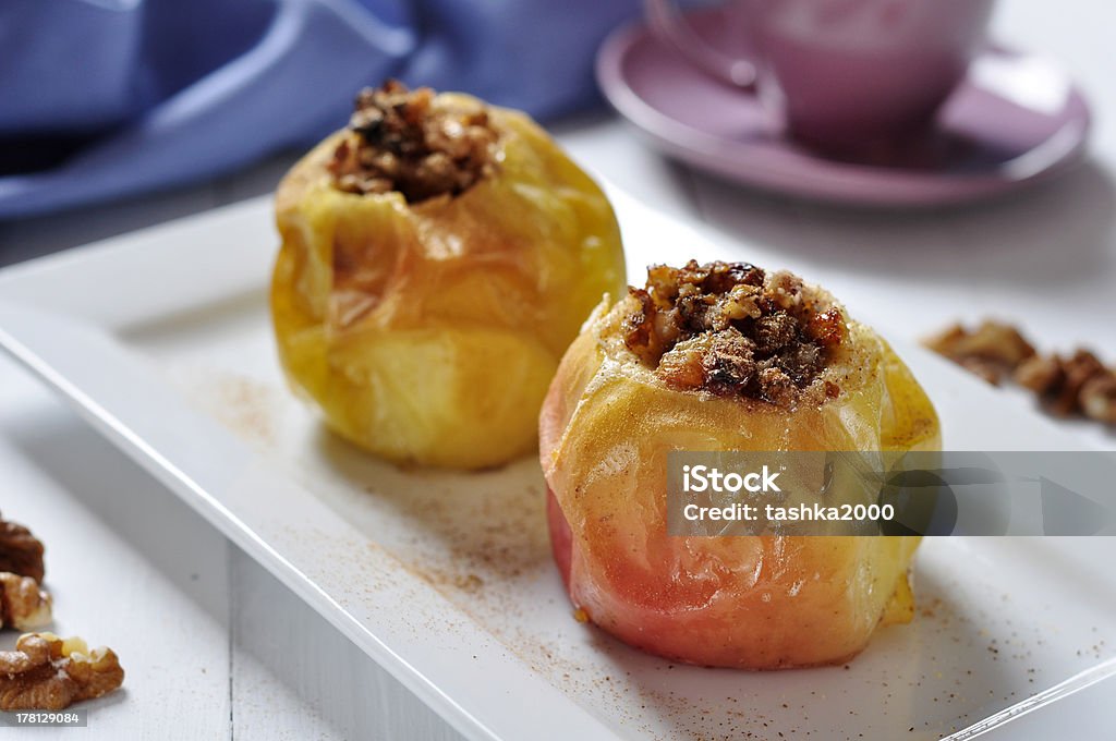 Baked apples Baked apples on white plate with cup of tea Apple - Fruit Stock Photo