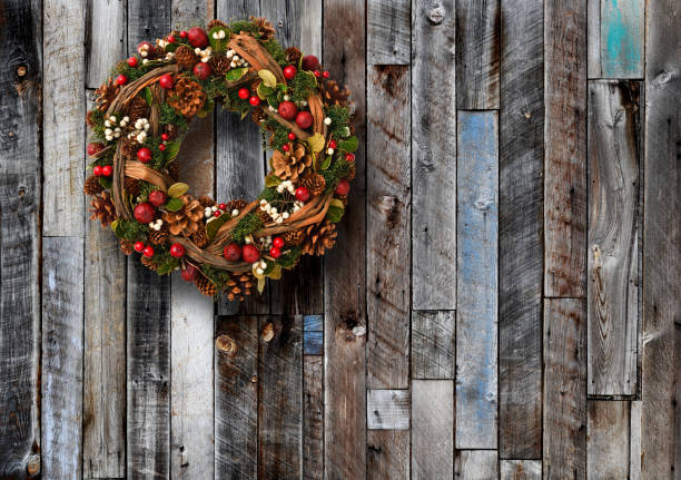 istock Christmas wreath hanging on a weathered old wood boards wall 1781295466
