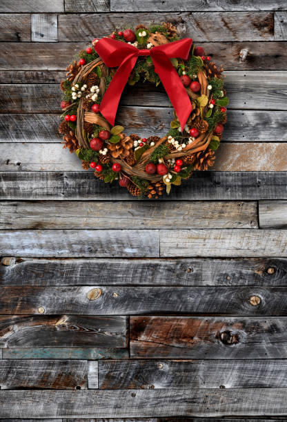 istock Christmas wreath hanging on a weathered old wood boards wall 1781295468