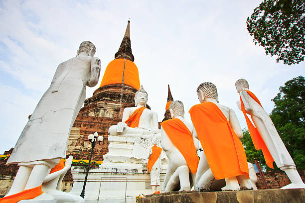 istock White buddha statues praying in front of the ancient pagoda 178129746
