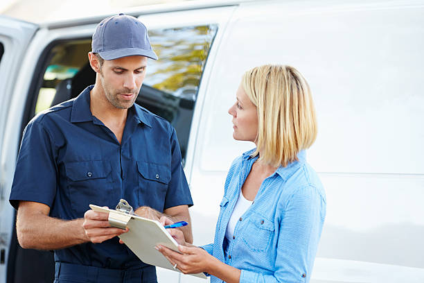 istock A customer signing for a delivery from a courier 178129824