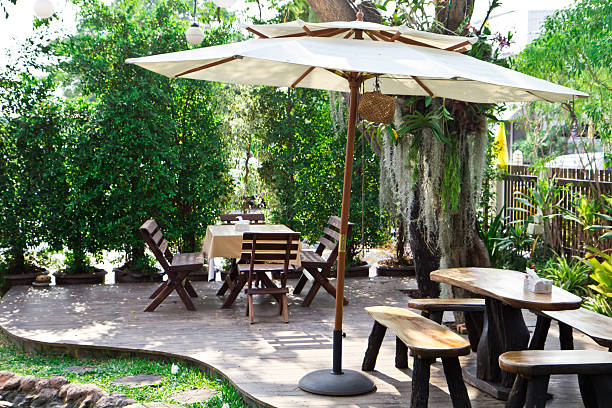 istock table with chairs and umbrella in garden 178130773