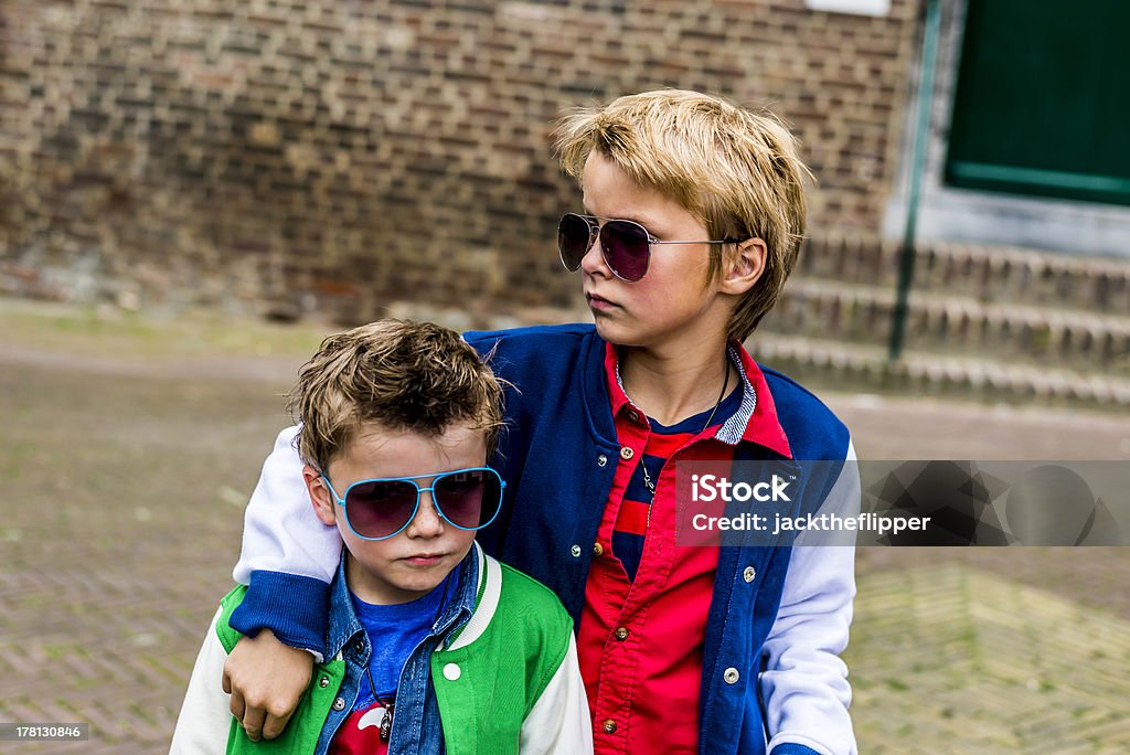 bad boys two cool kids with sunglasses looking tough Boys Stock Photo
