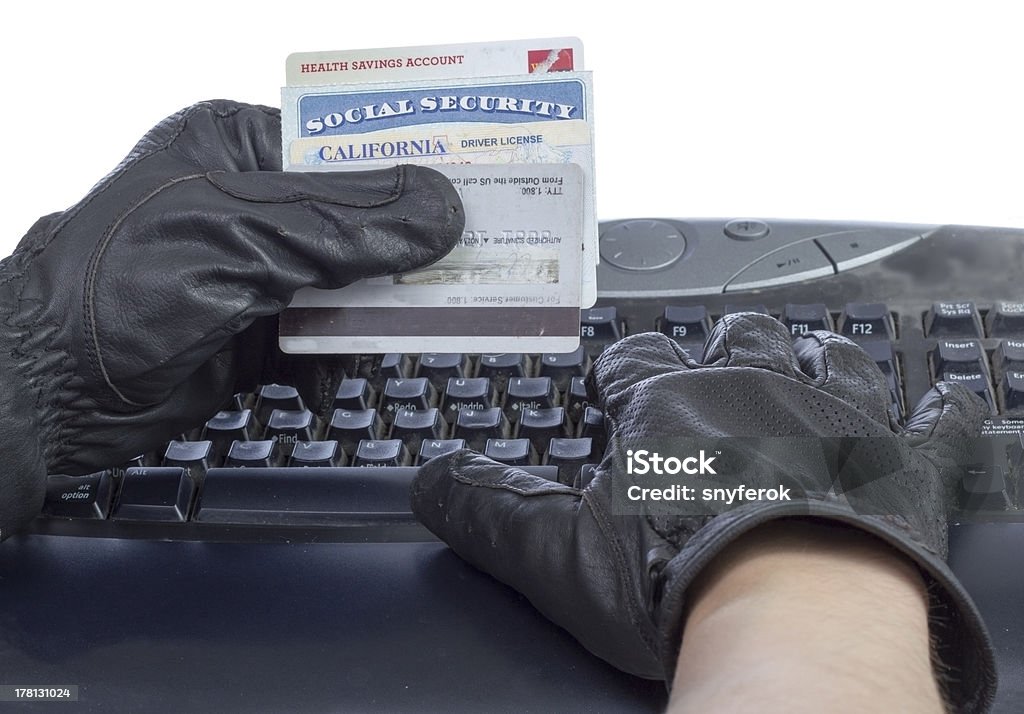 Identity theft. Identification documents (social security, driver license and credit cards) in hand of thief, isolated on white. Identity Theft Stock Photo