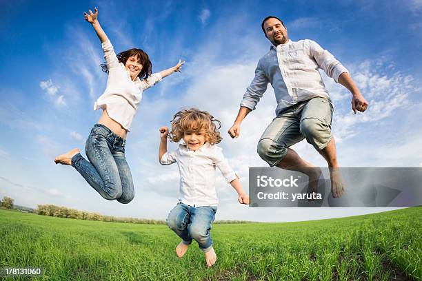 Happy Active Family Jumping Stock Photo - Download Image Now - Active Lifestyle, Activity, Adult