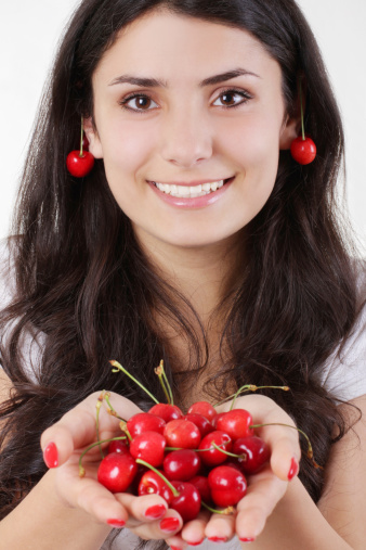 Pretty woman with cherry fruit