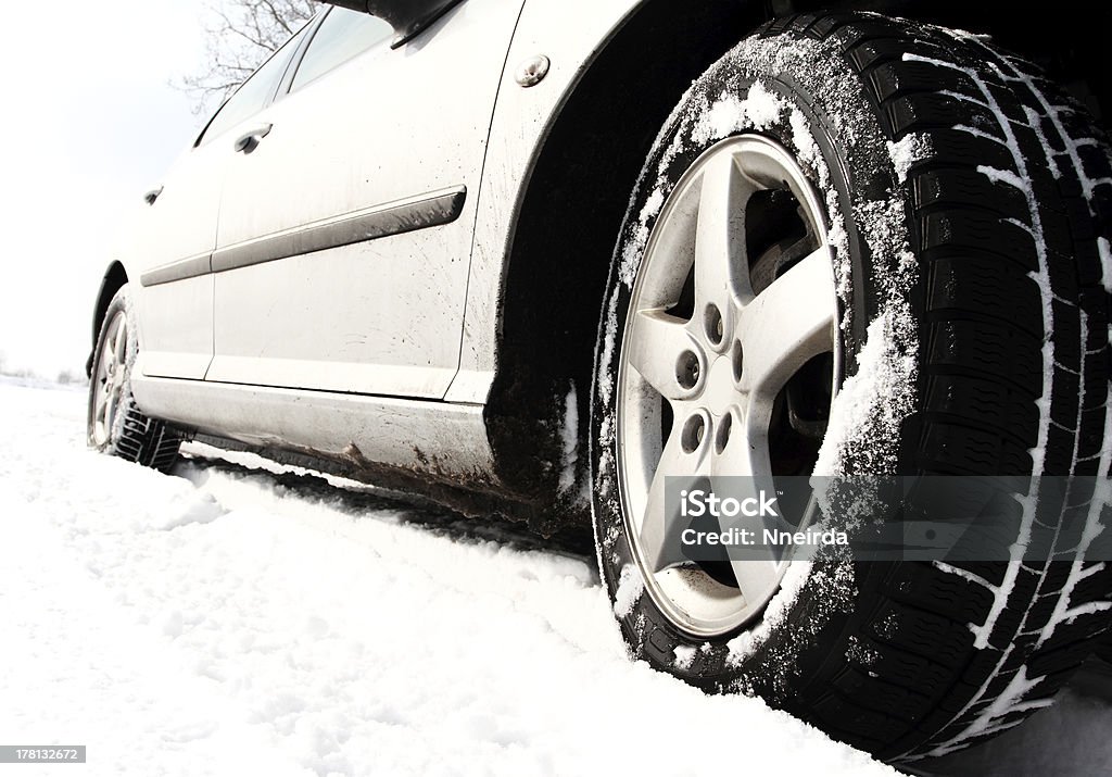 Winter tyre Close up of a cars tires on a snowy road Car Stock Photo