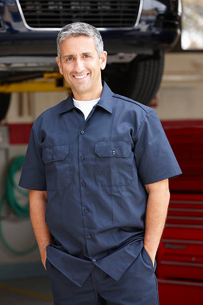 istock A car mechanic at work smiling at the camera 178132858