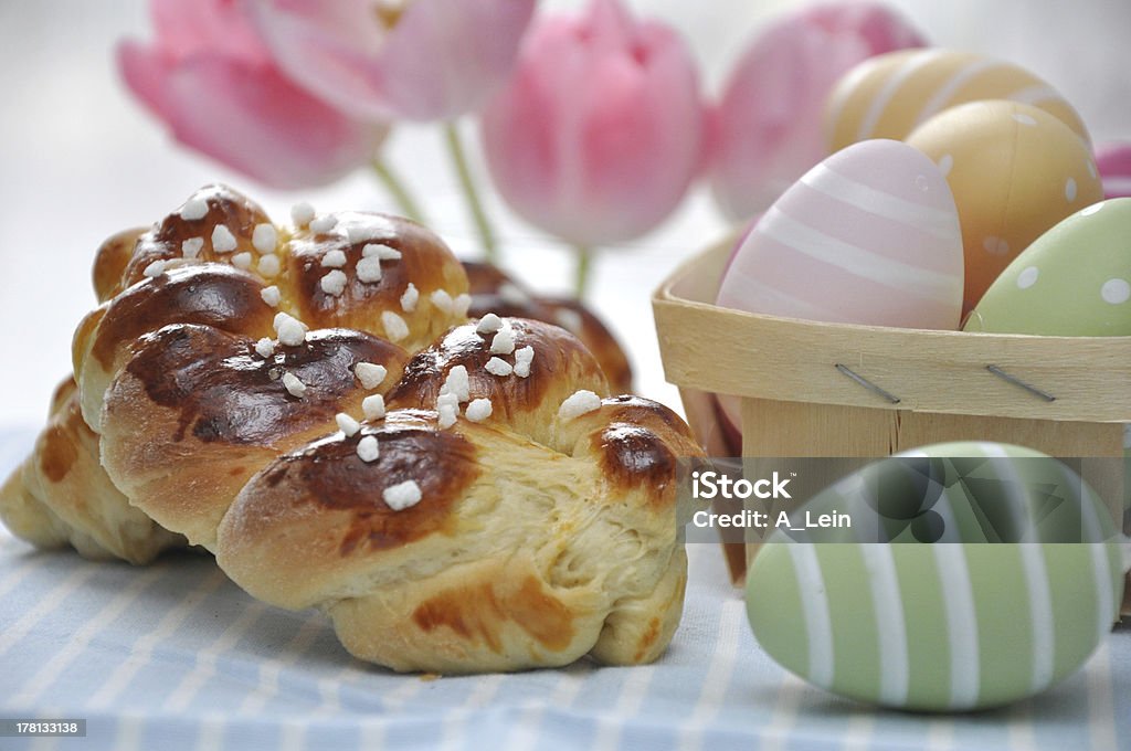 Sweet braided easter bread Sweet braided easter bread with tulips and easter eggs Yeast Stock Photo