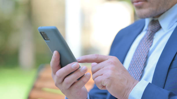 istock Close Up of Businessman Using Phone while Sitting Outdoor 1781342796