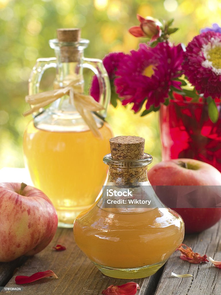 Apple cider vinegar Apple cider vinegar in glass bottle, selective focus Bottle Stock Photo