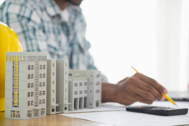 istock Construction engineers are checking blueprints and calculating their accuracy after receiving plans from architect in order start  construction safely. Inspection Concept from construction engineering 1781349252