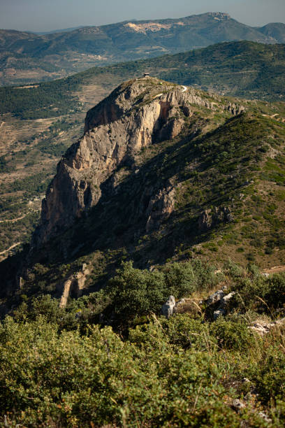 Views of a hut on top of another mountain in Alicante from Cabeçó d'Or stock photo