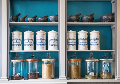 assortment of spice jars on shelves with price tags