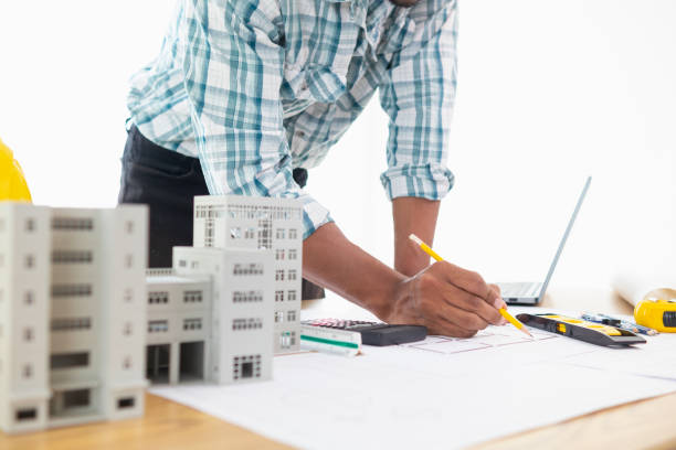 istock Construction engineers are checking blueprints and calculating their accuracy after receiving plans from architect in order start  construction safely. Inspection Concept from construction engineering 1781354605