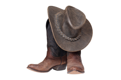 Cowboy boots and hat isolated over white with clipping path
