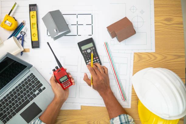 istock Construction engineers are checking blueprints and calculating their accuracy after receiving plans from architect in order start  construction safely. Inspection Concept from construction engineering 1781356761