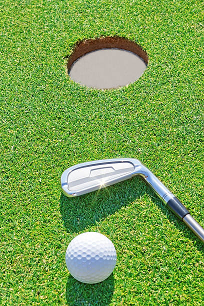 istock Golf putter ball near the hole in vertical format. 178135976