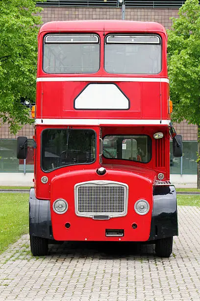 big red double decker bus on the street