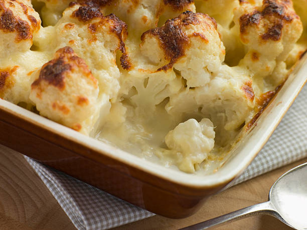 Serving of Cauliflower Cheese in Cooking Dish on Kitchen Table