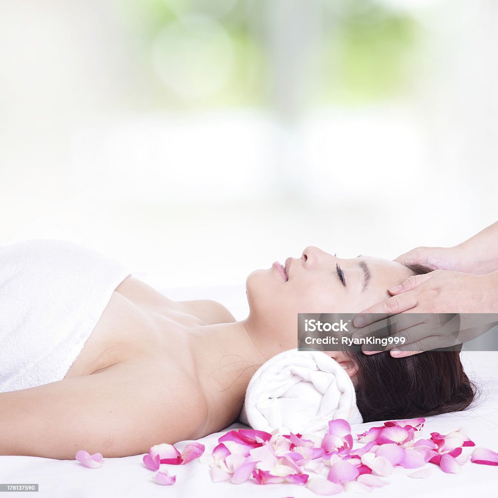woman enjoy face and head massage at spa Beautiful asian woman enjoy receiving face and head massage at spa with nature green backgroundModel: Massaging Stock Photo