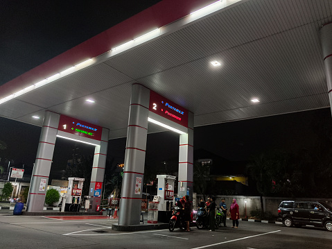 Tangerang, Indonesia - October 14, 2023: Two-wheeled vehicle filling petrol at a gas station in Tangerang, Indonesia