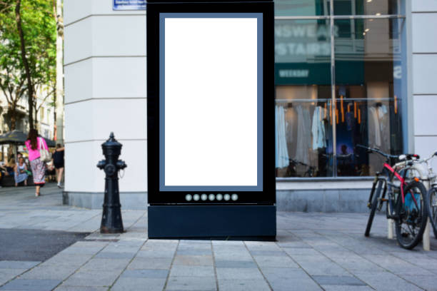 istock blank billboard, lightbox ad panel along sidewalk. outdoor advertising sign panel mockup. European streetscape 1781386620