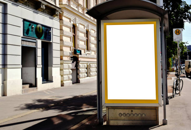 istock blank billboard, lightbox and ad panel along asphalt sidewalk. outdoor advertising sign mockup. European streetscape 1781386624