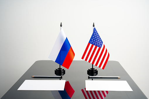 Flags of Usa and Russia on negotiation table close up