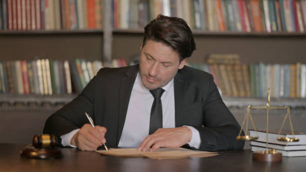 istock Pensive Male Lawyer Writing Documents in Office 1781393125
