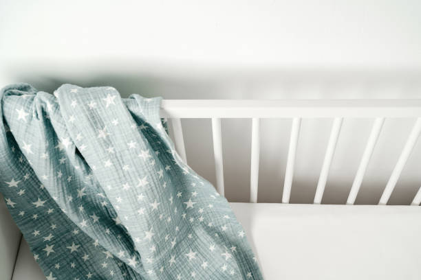 istock Soft blue muslin blanket hanging on a baby's bed 1781397798