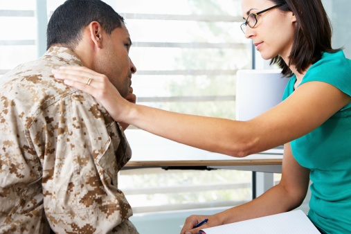 Depressed Soldier Having Counselling Session Looking At Counsellor Concerned