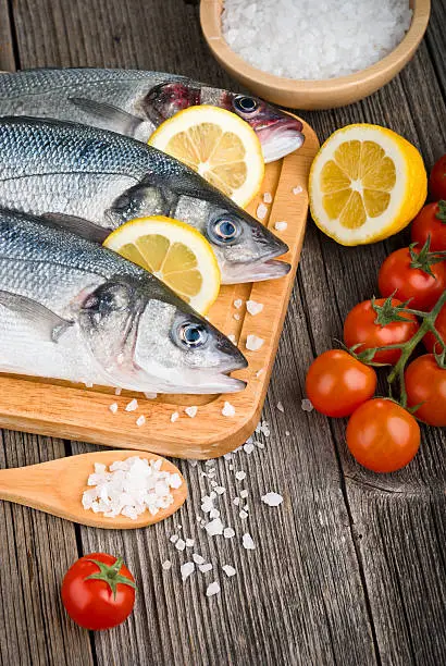 Photo of Fresh sea bass on chopping board