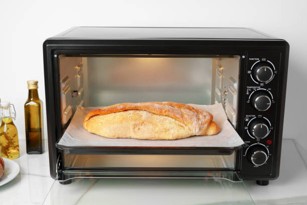 istock Freshly baked bread in mini oven in the kitchen 1781442968