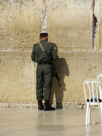 Jerusalem, Israel - May 15, 2015: Israeli Defense Forces IDF soldier praying at the Western Wall in Jerusalem