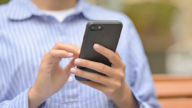 istock Close Up of Hispanic Woman Using Phone while Sitting Outdoor 1781447892
