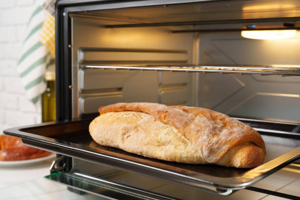 istock Freshly baked bread in mini oven in the kitchen 1781451632