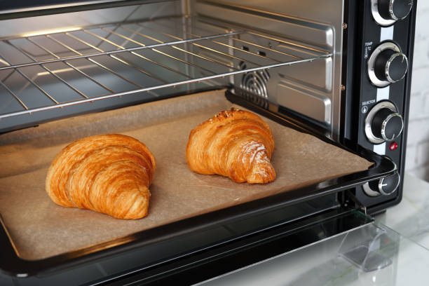 istock Modern mini electric oven with freshly baked croissants in kitchen 1781457097