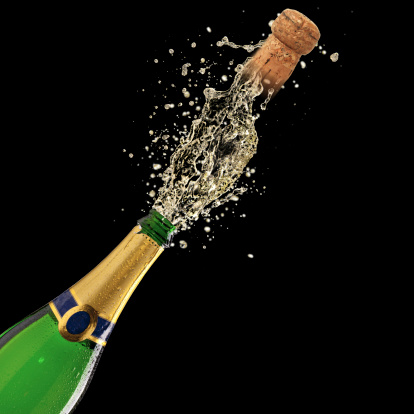 Bottle of champagne with splash on black background