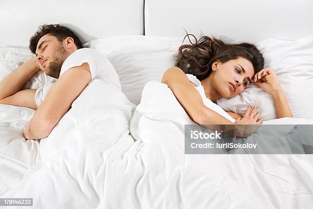 Upset Couple Lying In Bed Stock Photo - Download Image Now - Adult, Adults Only, Anger