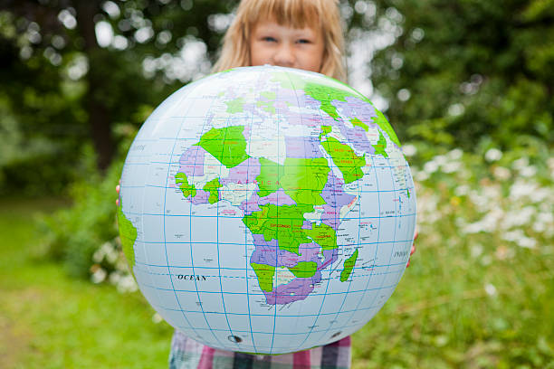 istock Girl holding an earth globe 178147156