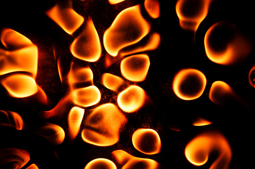 Beautiful liquid red, orange fire texture on black background. Fire in waves