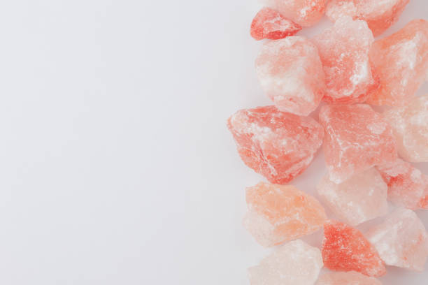 istock Raw rose quartz crystal stones on white background 1781478588