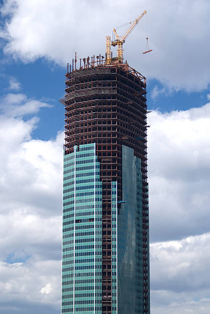 istock Tower crane on top of construction skyscraper 178148647