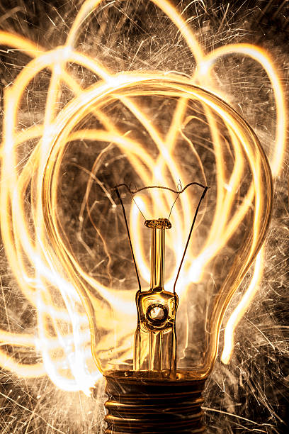 istock bulb and sparklers   on black background 178148987