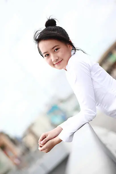 Vietnamese young girl in white traditional dress aodai (Ao Dai)