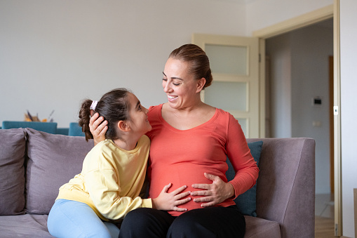 Love Between Pregnant Woman and Her Little Daughter