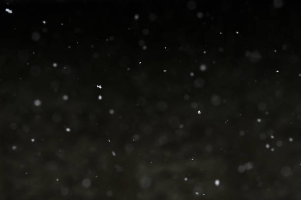 istock Bokeh of white snow on a black background. Snowfall - design element. 1781506390